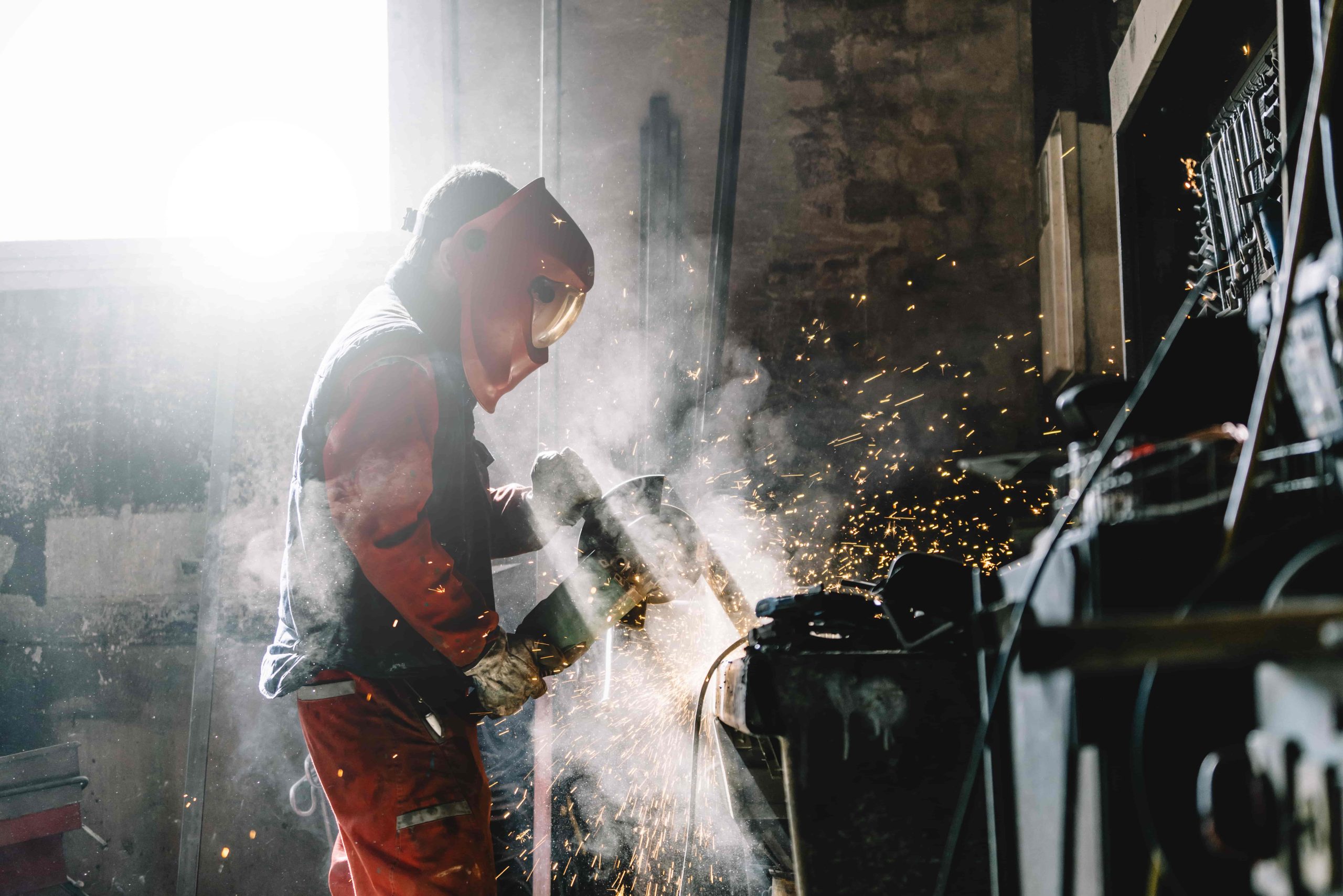 man-works-with-grinder-cutting-metal-2023-11-27-05-25-59-utc-min
