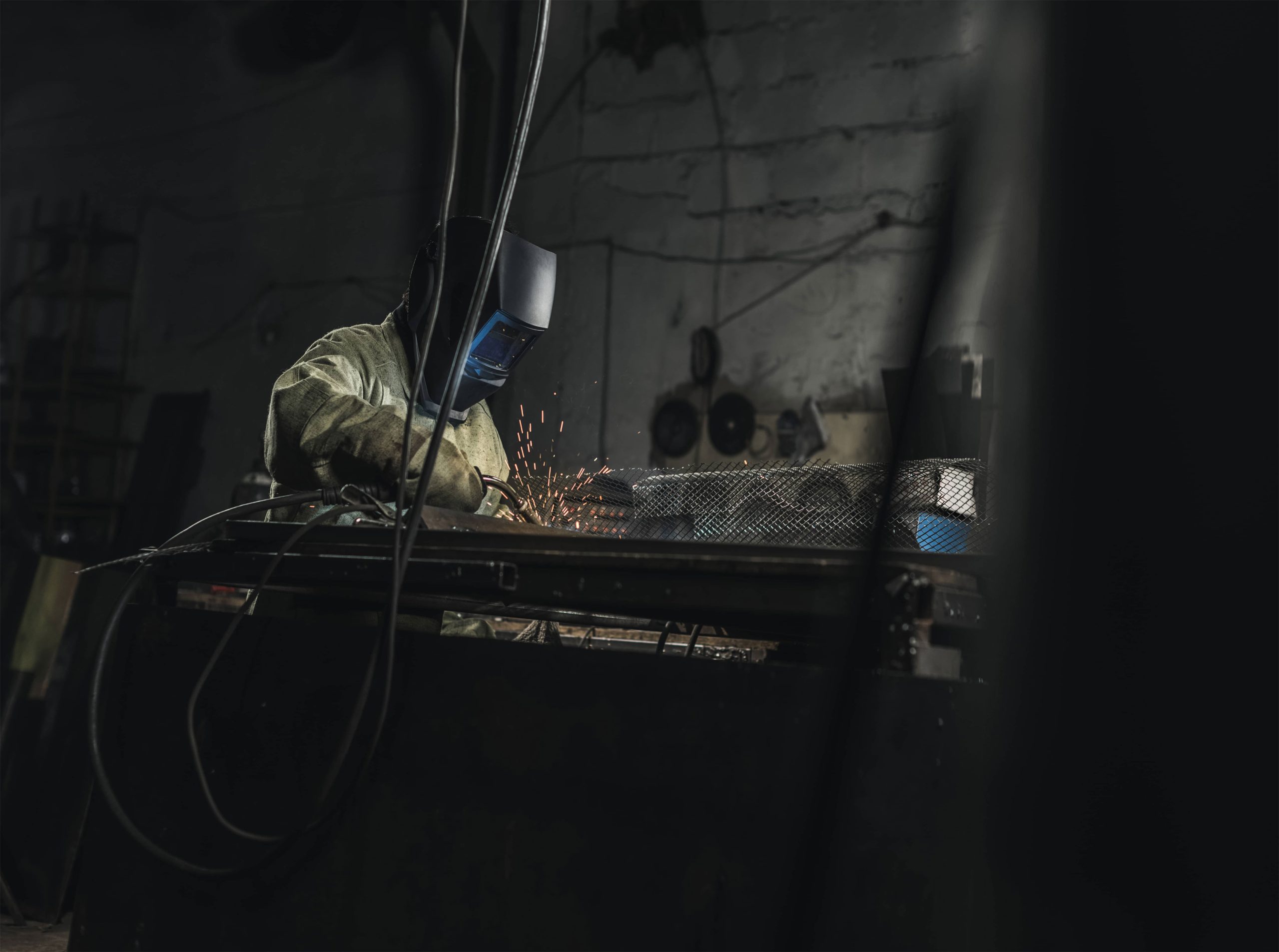 side-view-of-welder-in-protective-work-wear-workin-2024-11-08-21-27-51-utc-min
